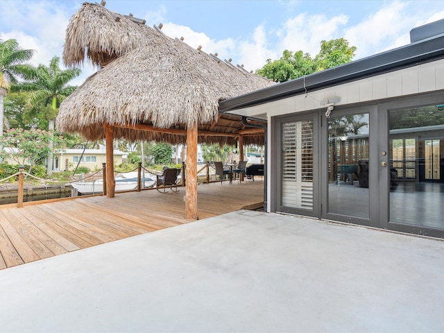 wooden terrace featuring a patio and a boat dock