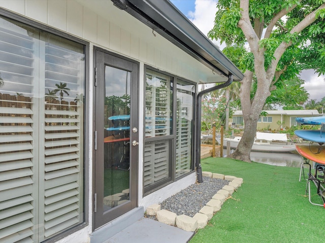 doorway to property featuring a lawn