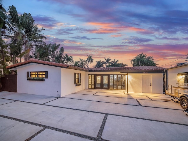 back house at dusk with a patio