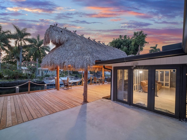 deck at dusk featuring a gazebo