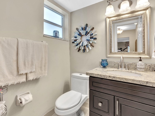 half bathroom featuring toilet and vanity