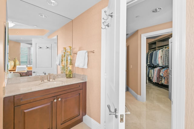 bathroom featuring walk in shower and vanity