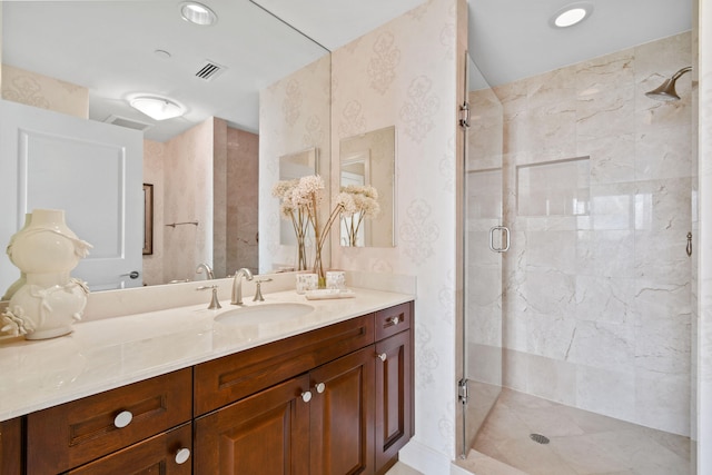 bathroom featuring vanity and a shower with shower door