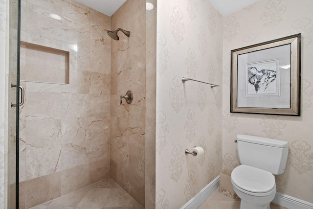 bathroom featuring toilet and a shower with shower door