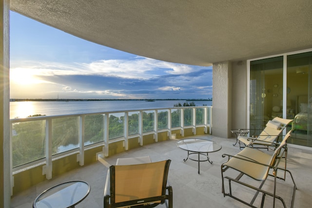 balcony at dusk with a water view