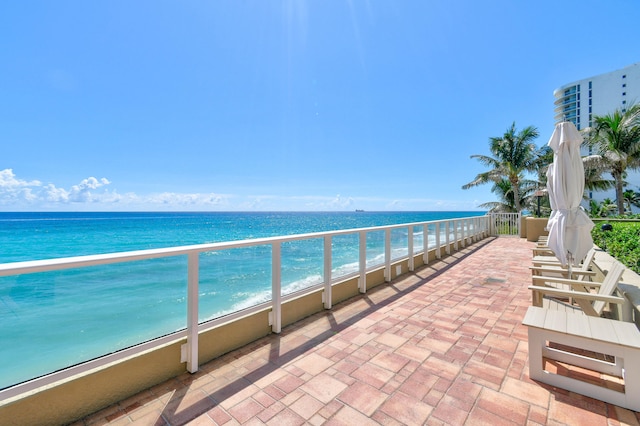 view of patio with a view of the beach and a water view