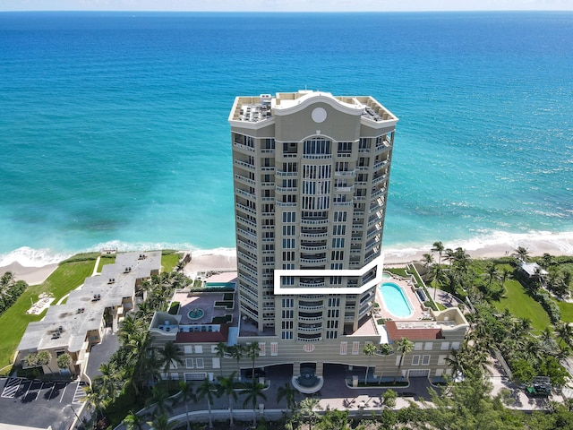 bird's eye view featuring a water view and a beach view