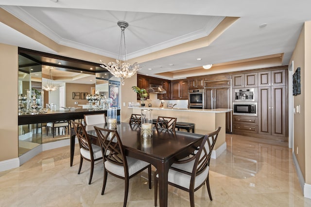 dining area with crown molding, an inviting chandelier, and a tray ceiling