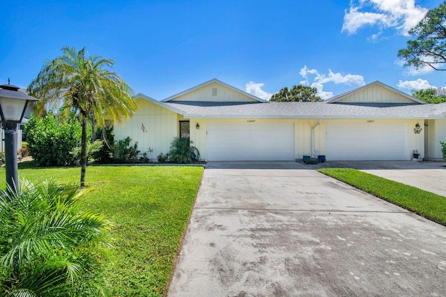 ranch-style house featuring a front lawn and a garage