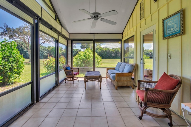 sunroom / solarium featuring lofted ceiling and plenty of natural light