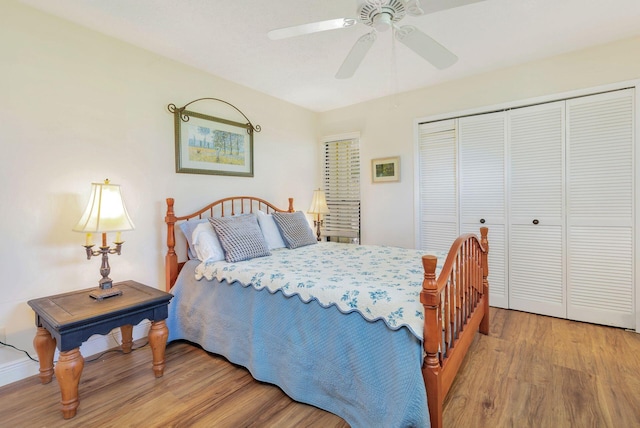 bedroom with a closet, wood-type flooring, and ceiling fan