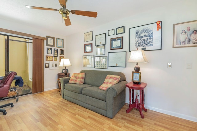 living room with light hardwood / wood-style floors and ceiling fan