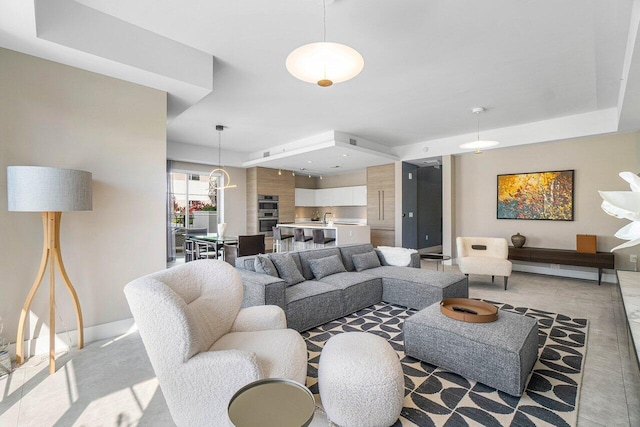 living room with sink and a notable chandelier