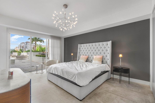 bedroom featuring access to outside and a notable chandelier