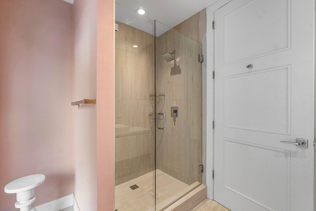 bathroom featuring a shower with shower door