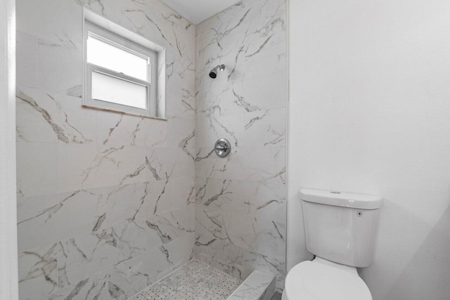 bathroom with toilet and tiled shower