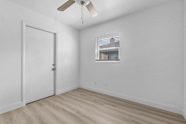 unfurnished room featuring a textured ceiling, ceiling fan, and light hardwood / wood-style flooring