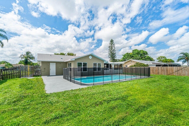 view of pool with a lawn and a patio area