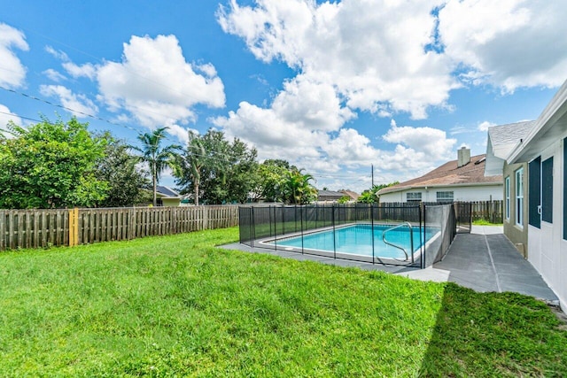 view of swimming pool with a lawn and a patio area