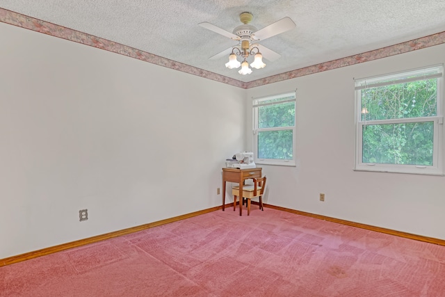 carpeted spare room featuring a textured ceiling and ceiling fan