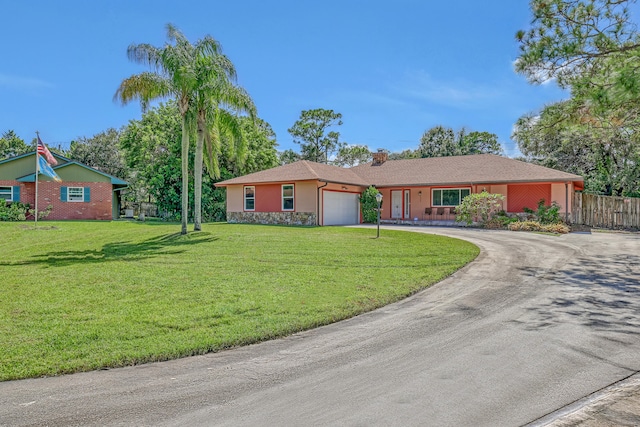 ranch-style home with a front lawn and a garage