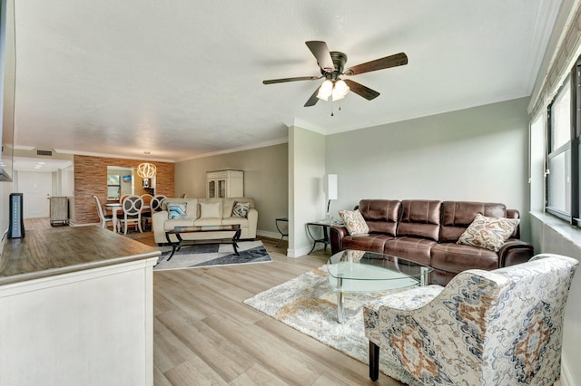 living room featuring ornamental molding, ceiling fan, and light hardwood / wood-style flooring