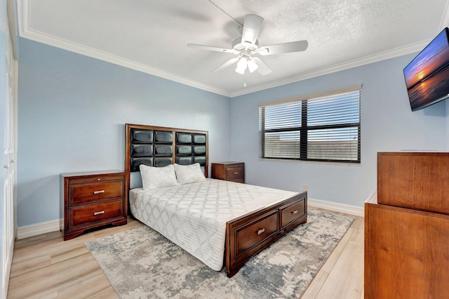 bedroom with light wood-type flooring, ornamental molding, and ceiling fan