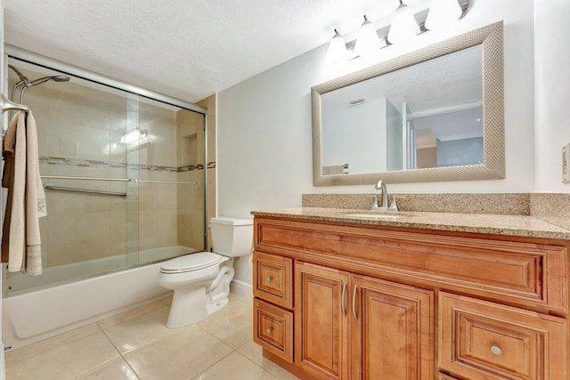 full bathroom with enclosed tub / shower combo, vanity, toilet, a textured ceiling, and tile patterned flooring