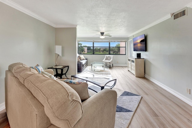 living room with a textured ceiling, crown molding, light hardwood / wood-style floors, and ceiling fan