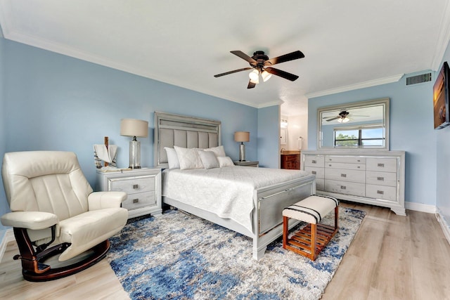 bedroom with light hardwood / wood-style floors, ornamental molding, ensuite bath, and ceiling fan