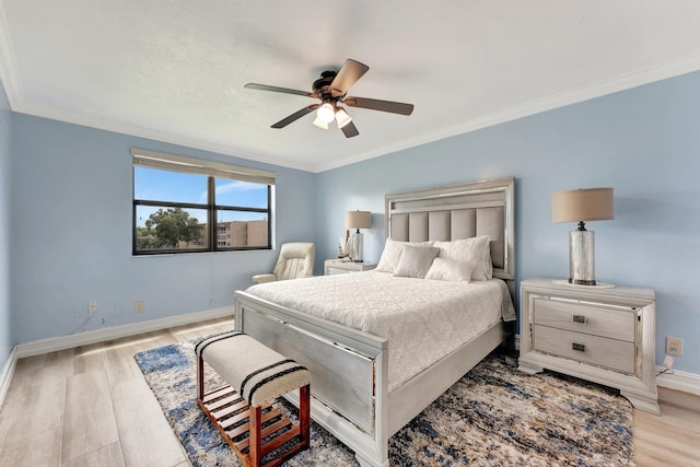 bedroom with ceiling fan, ornamental molding, and light hardwood / wood-style floors