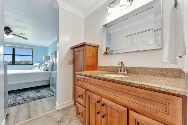 bathroom with ornamental molding, vanity, ceiling fan, and wood-type flooring