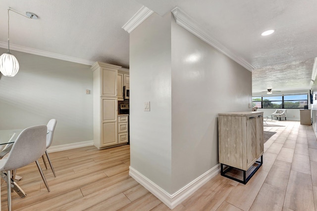 corridor featuring ornamental molding, a textured ceiling, and light hardwood / wood-style floors