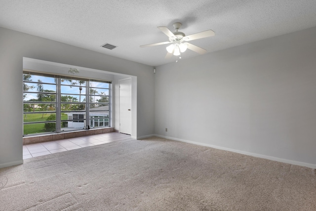 unfurnished room with light carpet, a textured ceiling, and ceiling fan