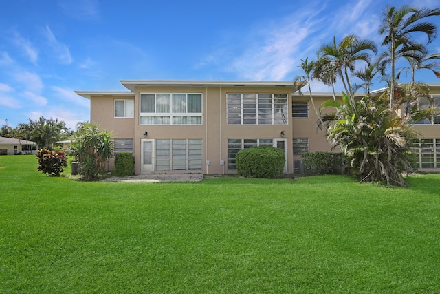 rear view of property featuring a yard