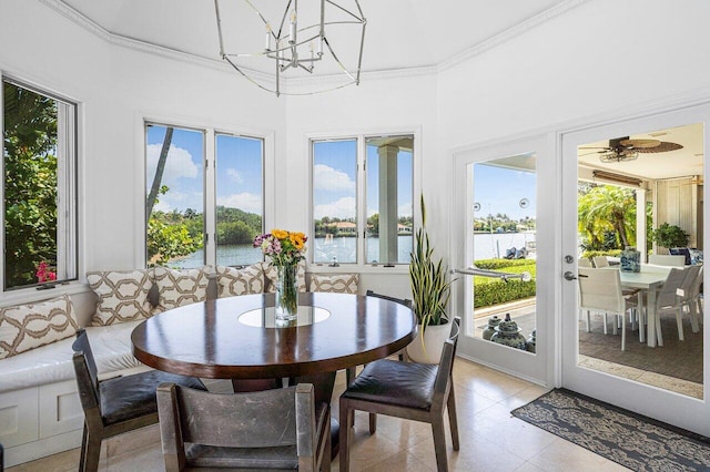 sunroom with ceiling fan, a water view, and a healthy amount of sunlight