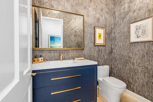 bathroom featuring tile patterned floors, vanity, and toilet