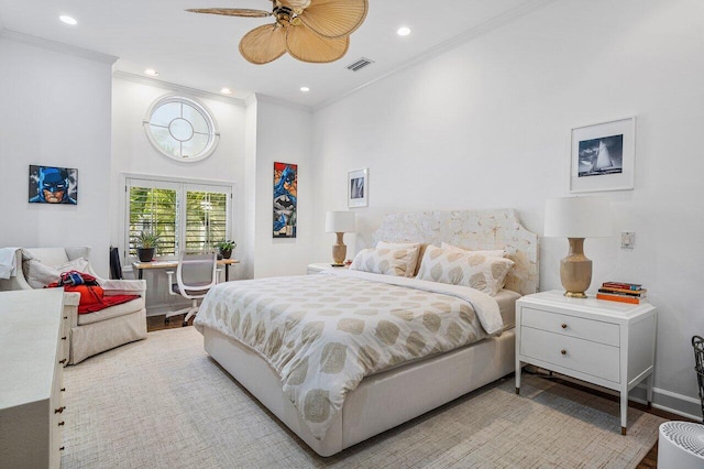 bedroom with light hardwood / wood-style floors, ceiling fan, and crown molding