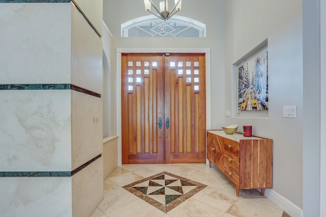 entrance foyer featuring an inviting chandelier