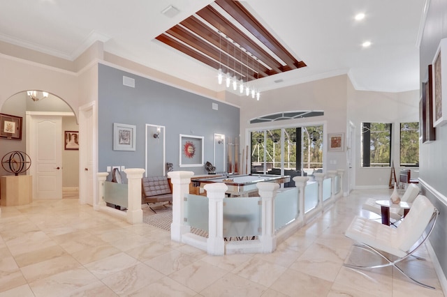 kitchen with ornamental molding and a high ceiling