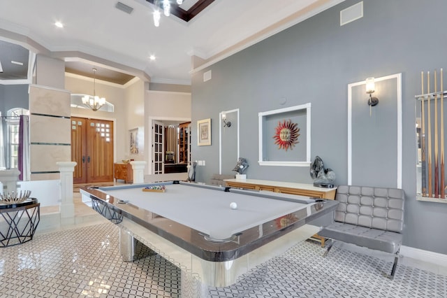 recreation room with light tile patterned flooring, ornamental molding, pool table, a high ceiling, and an inviting chandelier