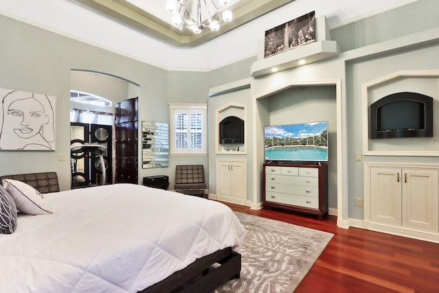 bedroom featuring an inviting chandelier, crown molding, and dark hardwood / wood-style flooring