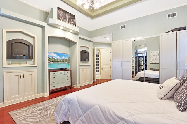 bedroom featuring connected bathroom, a closet, and dark hardwood / wood-style flooring