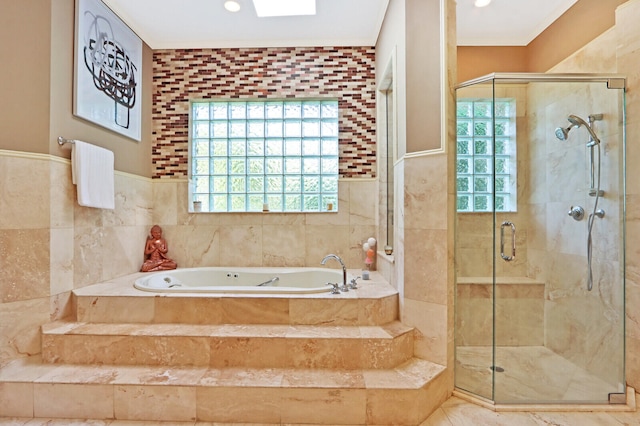 bathroom with independent shower and bath and tile walls