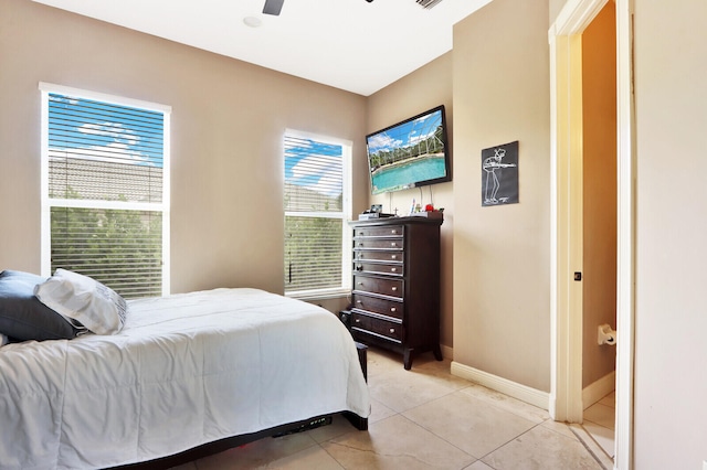 tiled bedroom with ceiling fan