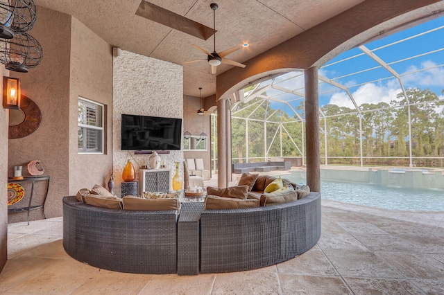 view of patio / terrace with a lanai, ceiling fan, and outdoor lounge area