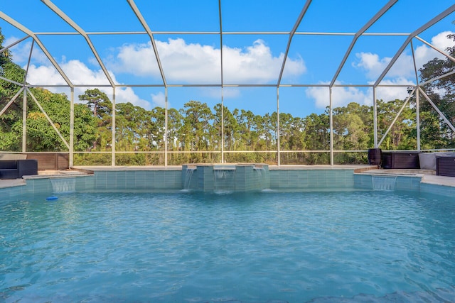 view of swimming pool with a hot tub, a lanai, and pool water feature