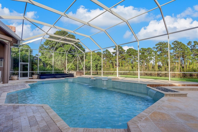 view of swimming pool featuring a hot tub, a patio area, a lanai, and pool water feature