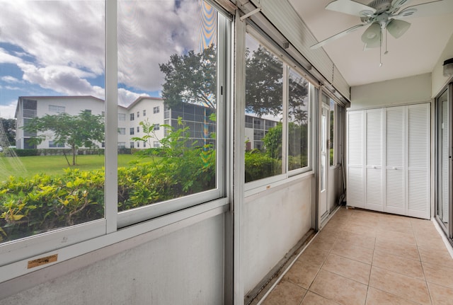 unfurnished sunroom with ceiling fan