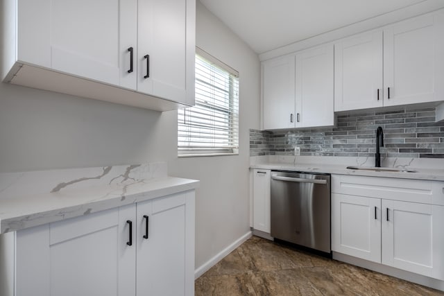 kitchen featuring dishwasher, sink, and white cabinetry